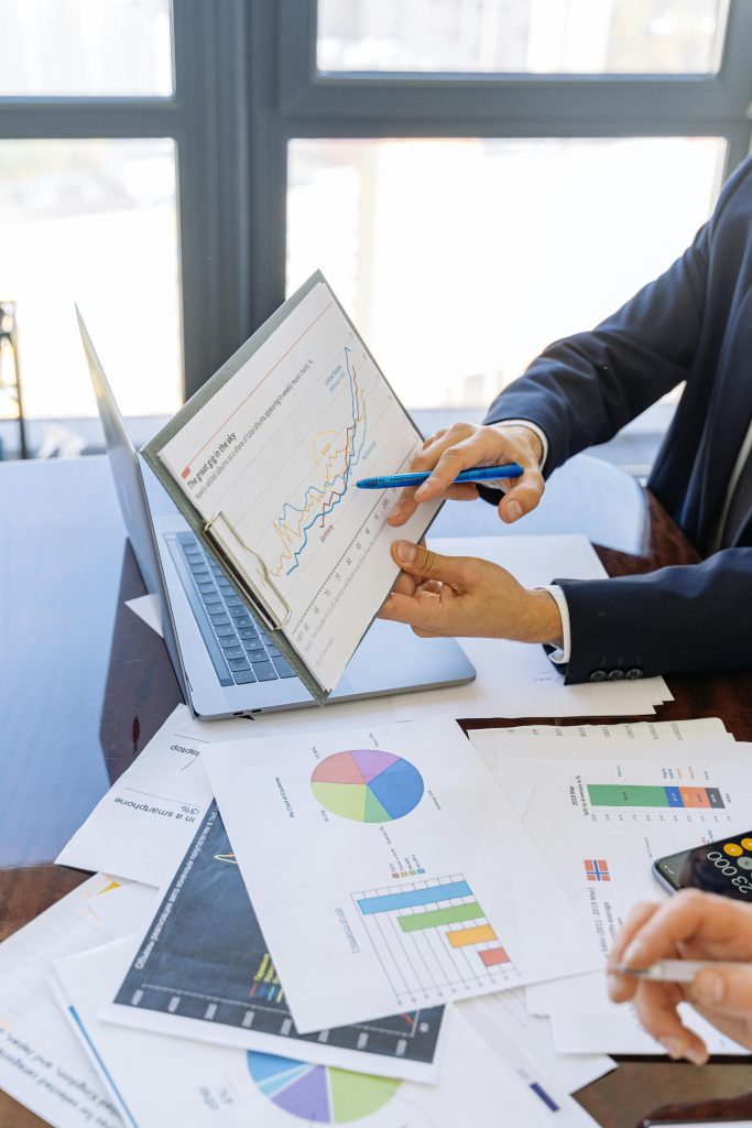 pexels-photo-5816299-5816299 Business professionals discussing financial graphs and charts in an office setting.